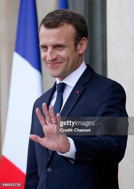 French president Emmanuel Macron smiles as Canadian Prime Minister Justin Trudeau leaves the Elysee Palace after their meeting on April 16, 2018 in...