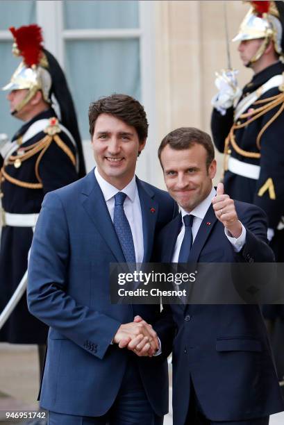 French president Emmanuel Macron accompanies Canadian Prime Minister Justin Trudeau after their meeting at the Elysee Palace on April 16, 2018 in...