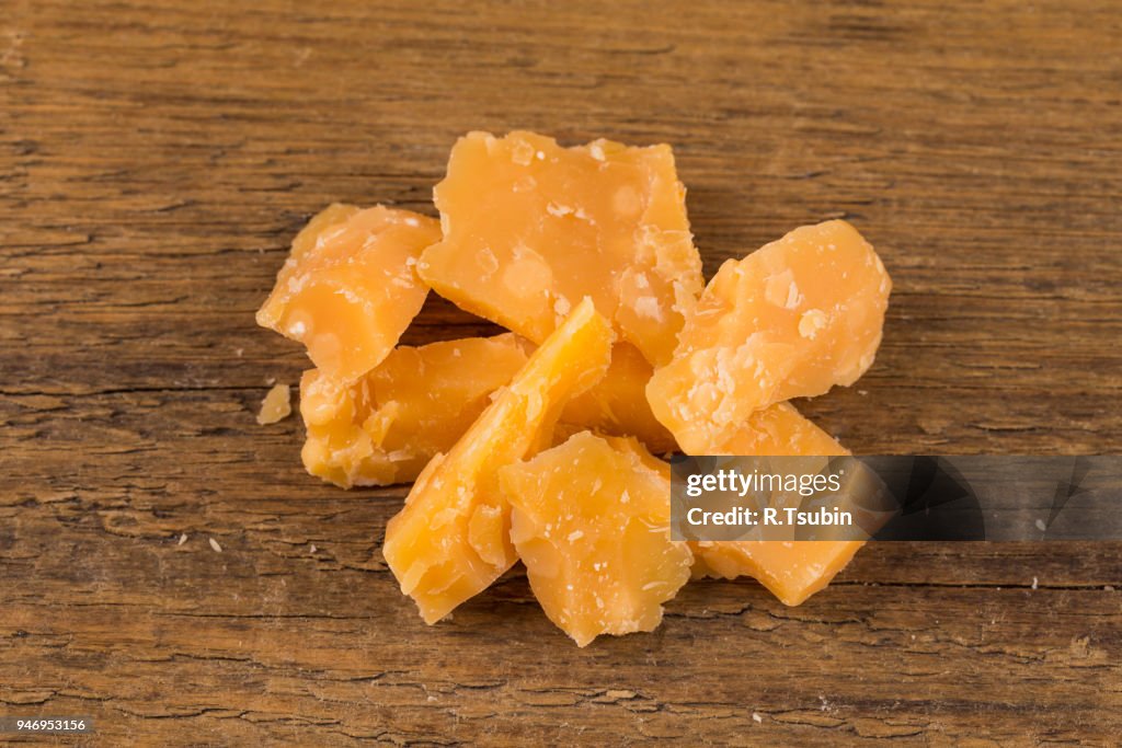 Italian Parmesan Cheese on Wooden Background close up