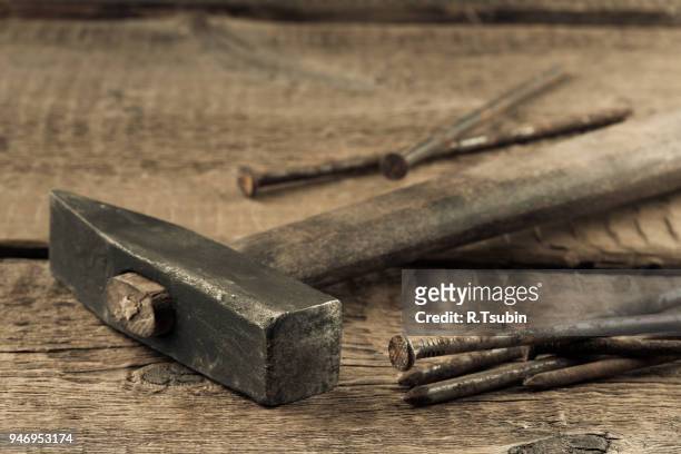 vintage old hammer with rusty nails on wood table background - bricolage stock-fotos und bilder