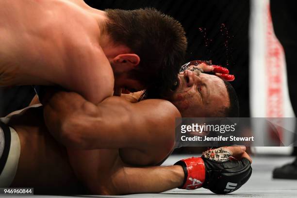 Carlos Condit strikes Alex Oliveira of Brazil in their welterweight fight during the UFC Fight Night at Gila River Arena on April 14, 2018 in...