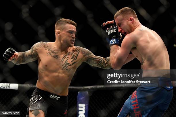 Dustin Poirier punches Justin Gaethje in their lightweight fight during the UFC Fight Night event at Gila River Arena on April 14, 2018 in Glendale,...