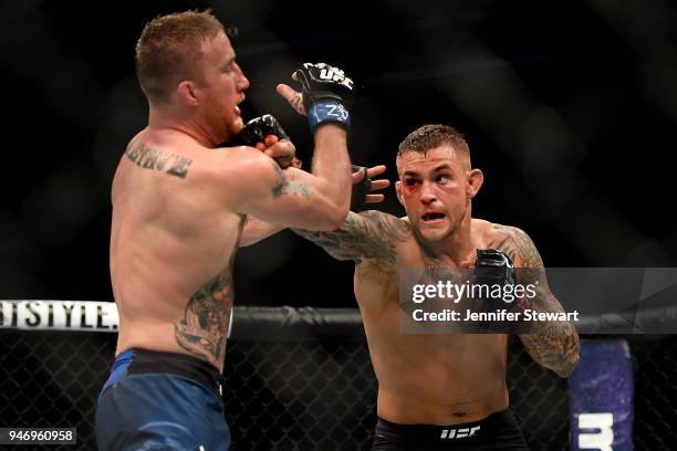 Dustin Poirier punches Justin Gaethje in their lightweight fight during the UFC Fight Night event at Gila River Arena on April 14, 2018 in Glendale,...