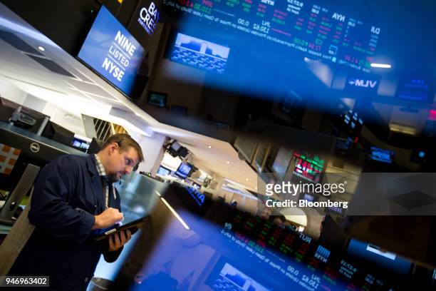 Trader works on the floor of the New York Stock Exchange in New York, U.S., on Monday, April 16, 2018. U.S. Stocks rallied and Treasuries slid as...