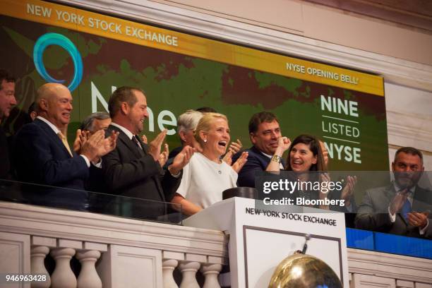 Ann Fox, president and chief executive officer of Nine Energy Service Inc., center, rings the opening bell on the floor of the New York Stock...