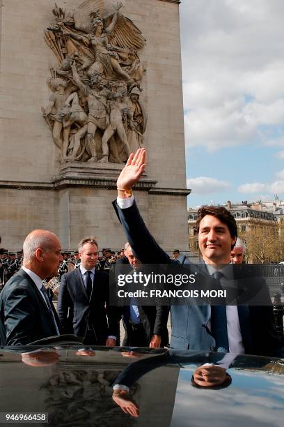 Canadian Prime Minister Justin Trudeau waves to onlookers as he enters his car after a wreath laying ceremony on the Tomb of the Unknown Soldier at...