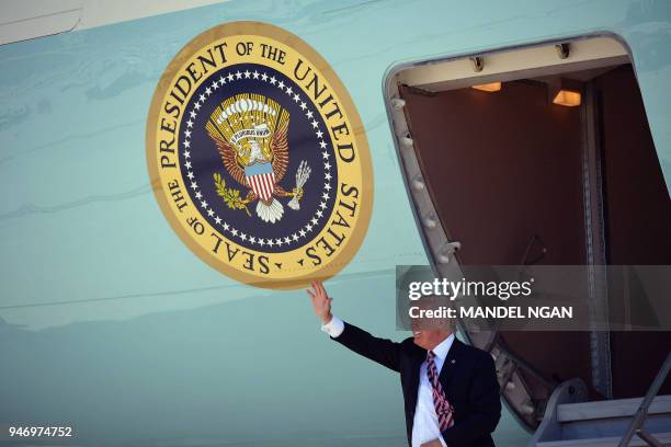 President Donald Trump steps off Air Force One upon arrival at Miami International Airport in Miami on April 16, 2018. - Trump is heading to Hialeah...