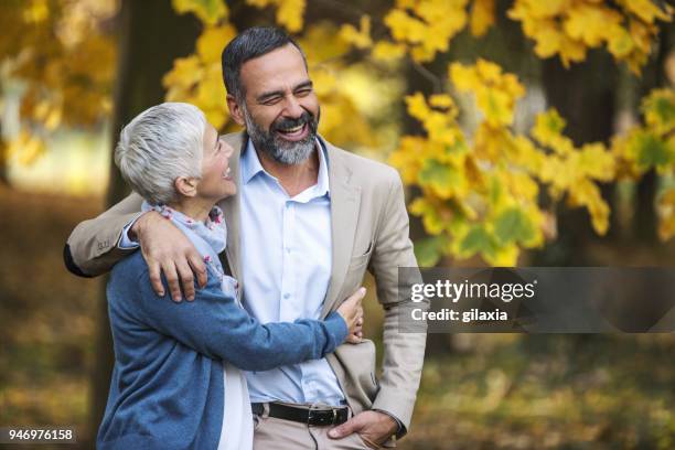 mid aged couple walking in a park. - november 2 2017 stock pictures, royalty-free photos & images