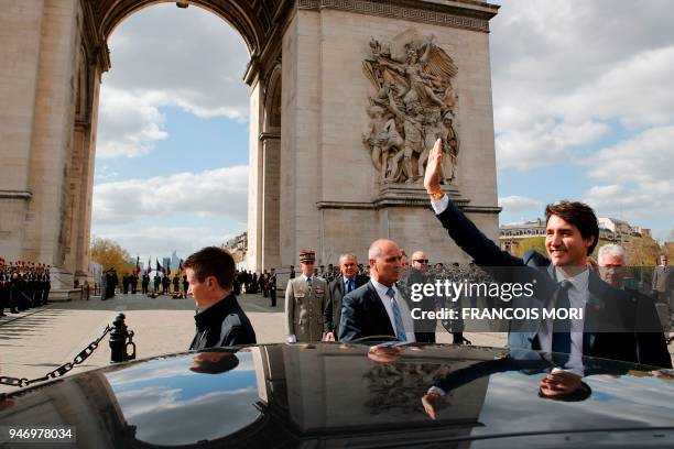 Canadian Prime Minister Justin Trudeau waves to onlookers as he enters his car after a wreath laying ceremony on the Tomb of the Unknown Soldier at...