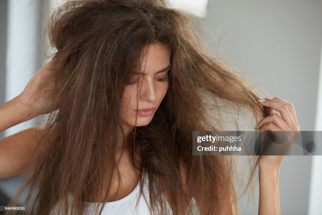 Woman With Holding Long Damaged Dry Hair. Hair Damage, Haircare.