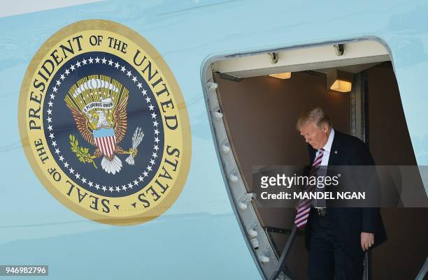 President Donald Trump steps off Air Force One upon arrival at Miami International Airport in Miami on April 16, 2018. - Trump is heading to Hialeah...