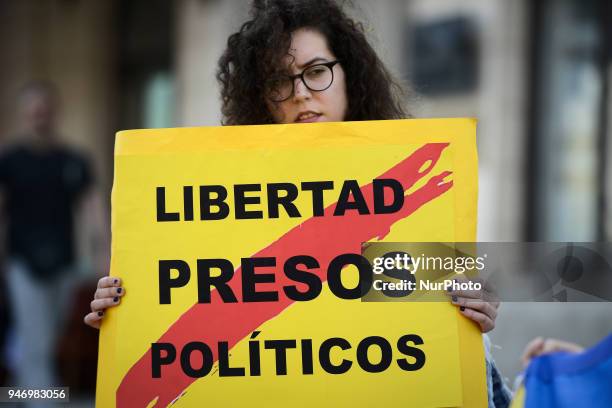 Woman holding a sign with the worlds &quot;Free pollitical prisonsers&quot; is seen during a rally of supporters for Catalonian independence from...