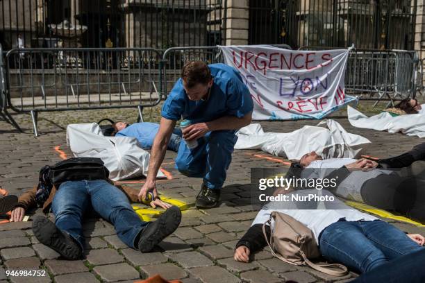 About fifty people, doctors, nurses and caregivers, demonstrated on April 16, 2018 on the Place de la Comedie in Lyon, France. Lying on the ground,...