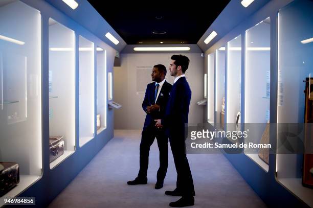 Members of staff look at a work by Loewe 'Time Capsule' by Louis Vuitton Exhibition on April 16, 2018 in Madrid, Spain.