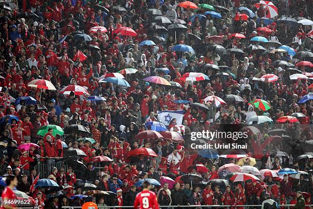 Hapoel Tel Aviv fans brave the rain to watch their team in action against Hamburger SV during their Group C Matchday 6 UEFA Europa League game on...