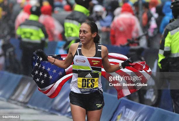 Boston Marathon women's winner Desiree Linden celebrates on Boylston Street after she crosses the finish line on April 16, 2018.