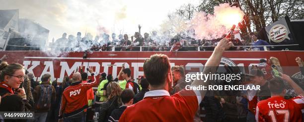 Eindhoven's players celebrate with their supporters a day after winning winning their 24th Dutch Eredivisie title on April 16 in Eindhoven. / AFP...