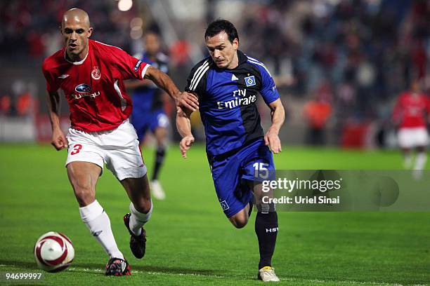 Douglas da Silva of Tel Aviv battles for the ball with Piotr Trochowski of HSV during their Group C UEFA Europa League match on December 17, 2009 in...