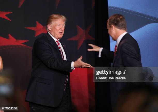 President Donald Trump is greeted by Rep. Mario Diaz-Balart as he arrives for a roundtable discussion about the Republican $1.5 trillion tax cut...