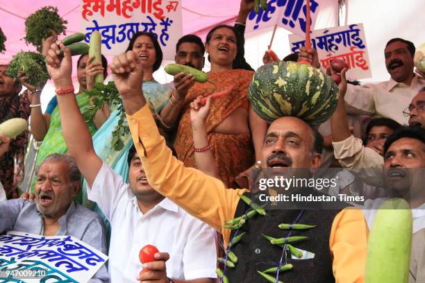 Leader Vijay Goel along with other BJP leaders protesting against "price rise" at Town Hall in New Delhi .