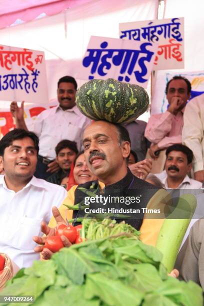 Leader Vijay Goel along with other BJP leaders protesting against "price rise" at Town Hall in New Delhi .