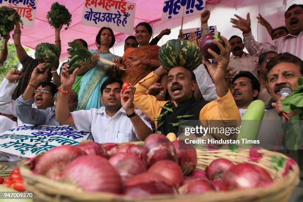 Leader Vijay Goel along with other BJP leaders protesting against "price rise" at Town Hall in New Delhi .