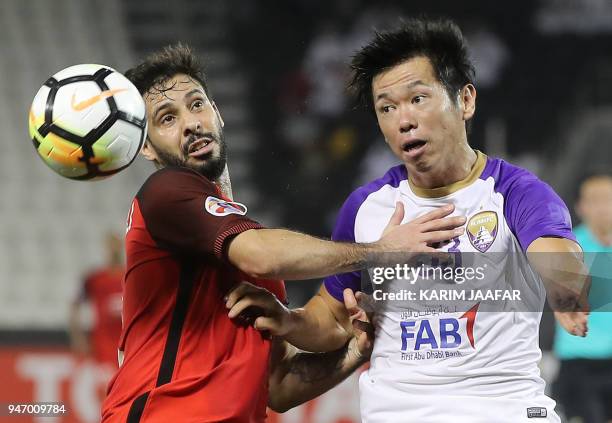 Al-Ain FC's Japanese midfielder Tsukasa Shiotani vies for the ball past Al-Rayyan SC's Moroccan midfielder Mouhcine Moutouali during their Asian...