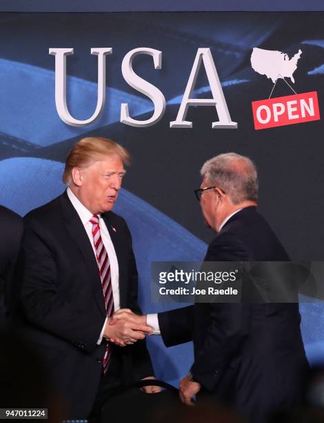 President Donald Trump is greeted by Guillermo Diaz-Rousselot as he arrives for a roundtable discussion about the Republican $1.5 trillion tax cut...