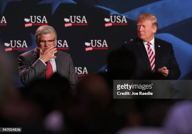 President Donald Trump listens as Maximo Alvarez speaks during a roundtable discussion about the Republican $1.5 trillion tax cut package he recently...
