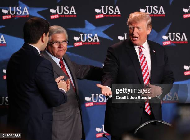 President Donald Trump greets Maximo Alvarez and Sen. Marco Rubio as he arrives for a roundtable discussion about the Republican $1.5 trillion tax...