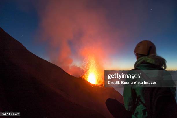 young woman watching volcanos' eruption - active volcano stockfoto's en -beelden