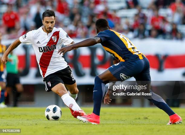 Ignacio Scocco of River Plate fights for the ball with Oscar Cabezas of Rosario Central during a match between River Plate and Rosario Central as...
