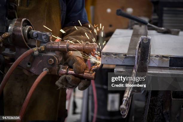 Worker use a spot welder on a metal door during production at the Metal Manufacturing Co. Facility in Sacramento, California, U.S., on Thursday,...