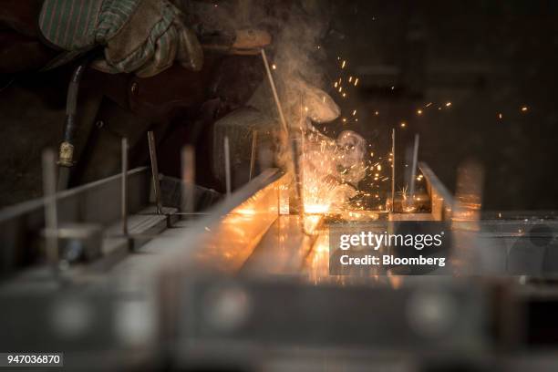 Worker arc welds a brace to a door at the Metal Manufacturing Co. Facility in Sacramento, California, U.S., on Thursday, April 12, 2018. The Federal...