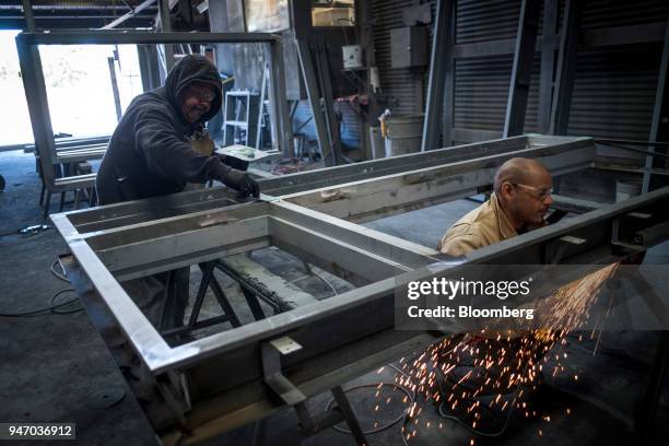 Workers construct window frames at the Metal Manufacturing Co. Facility in Sacramento, California, U.S., on Thursday, April 12, 2018. The Federal...