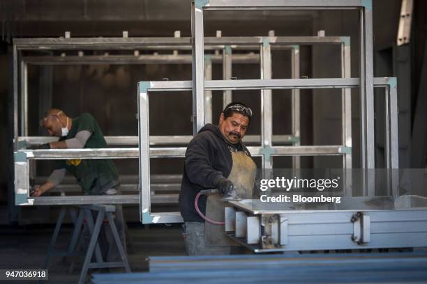 Workers constructs windows at the Metal Manufacturing Co. Facility in Sacramento, California, U.S., on Thursday, April 12, 2018. The Federal Reserve...