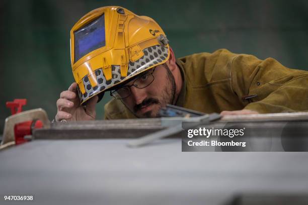 Worker uses a square to measure the side of a door during production at the Metal Manufacturing Co. Facility in Sacramento, California, U.S., on...