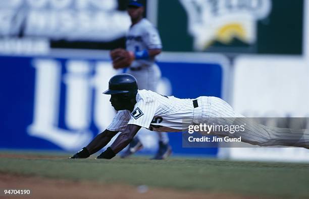 Michael Jordan of the Birmingham Barons dives into second during an August 1994 game against the Memphis Chicks at Hoover Metropolitan Stadium in...