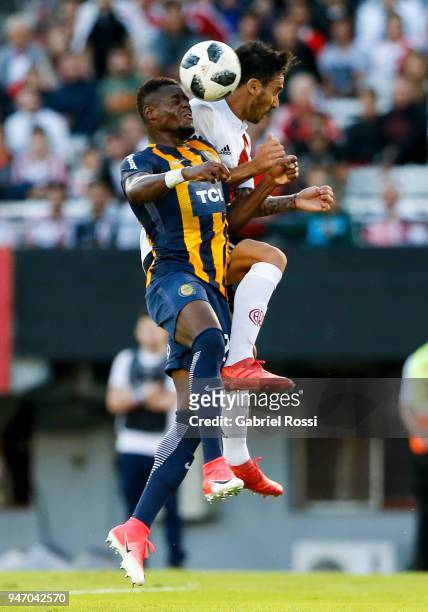 Ignacio Scocco of River Plate fights for the ball with Oscar Cabezas of Rosario Central during a match between River Plate and Rosario Central as...