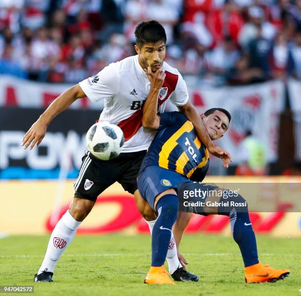 Luciano Lollo of River Plate fights for the ball with Joaquin Pereyra of Rosario Central during a match between River Plate and Rosario Central as...