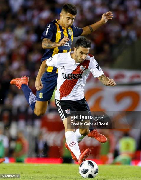 Ignacio Scocco of River Plate fights for the ball with Joaquin Pereyra of Rosario Central during a match between River Plate and Rosario Central as...