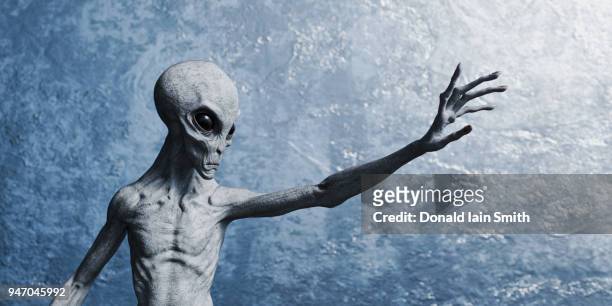 grey alien reaching out with hand - gray alien stock pictures, royalty-free photos & images