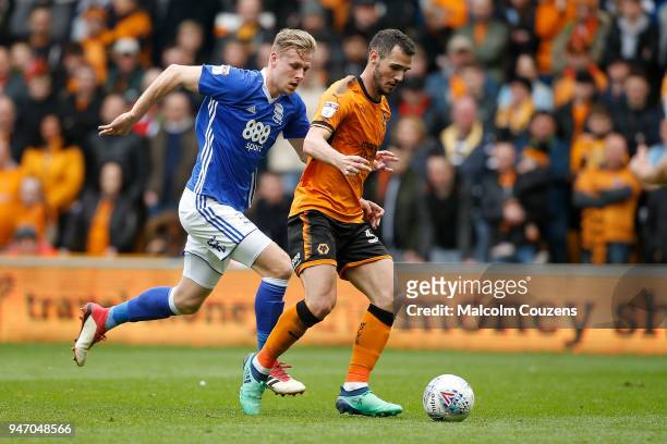 Leo Bonatini of Wolverhampton Wanderers runs with the ball ahead of Marc Roberts of Birmingham City during the Sky Bet Championship match between...