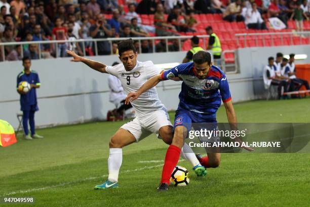 Al-Zawraa's Hussein Ali vies for the ball against Manama's Ali Haram during the AFC Cup football match between Iraq's Al-Zawraa club and Bahrain's...