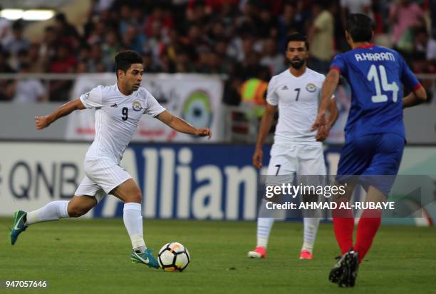Al-Zawraa's Hussein Ali dribbles the ball as Manama's Ali Haram defends during the AFC Cup football match between Iraq's Al-Zawraa club and Bahrain's...