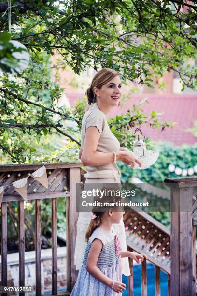 mother getting backyard ready for outdoors baptism. - christian baptism stock pictures, royalty-free photos & images
