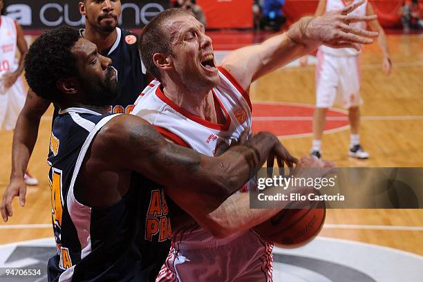 Mason Rocca, #12 of Armani Jeans Milano competes with Qyntel Woods, #24 of Asseco Prokom during the Euroleague Basketball Regular Season 2009-2010...