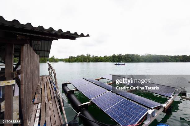 solar panels on a floating platform of a fish farm - sea pen stock-fotos und bilder