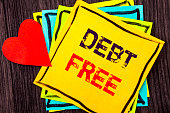 Writing text showing  Debt Free. Concept meaning Credit Money Financial Sign Freedom From Loan Mortage written on Stikcy Note Paper on the wood background Love Heart