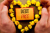 Conceptual writing showing Debt Free. Business photo showcasing Credit Money Financial Sign Freedom From Loan Mortage written on Sticky Note Paper With Heart Holding Hand with Finger